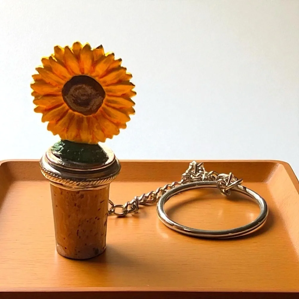 Vintage wine bottle cork stopper, with a pewter, painted, sunflower on top